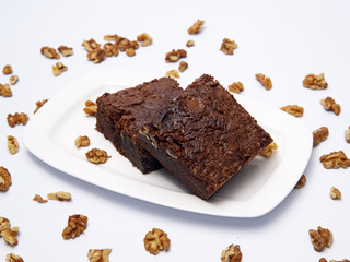 brownie cake served in a white plate on white background