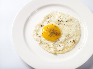 Bulls eye egg served in white plate on white background