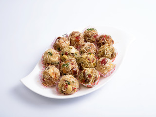 Dryfruits Laddu served in  a white plate on white background