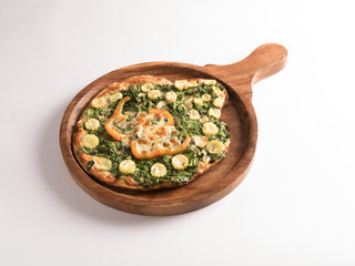 funghi Spinach corn pizza served in a wooden plate on white background