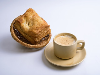 paneer puffs served in a bamboo basket with tea on white background
