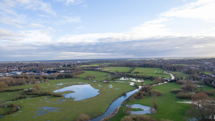 Naklejka na ściany i meble Aerial view of a lake and river area in the countryside late afternoon in the winter