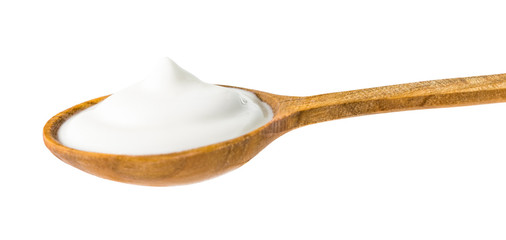 White Yogurt on Wooden Spoon Isolated on White Background