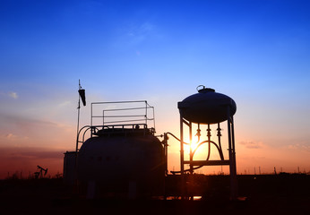 The oil tank, under the background of the setting sun
