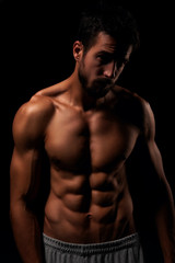 Fototapeta na wymiar Muscular and defined six pack abs on handsome male model