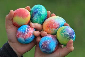 Toddlers hands holding colorful easter eggs