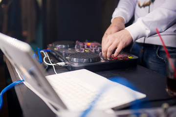 DJ mixing music on console at the night club