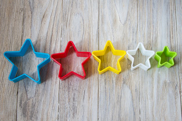 Bakeware in shape star on a wooden background, close up