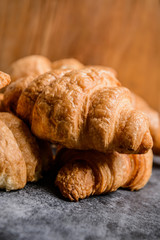Macro picture of croissants on grey table. 