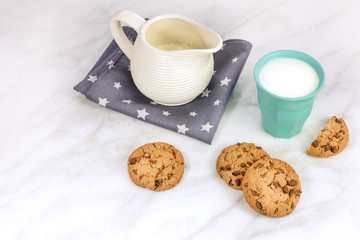 Chocolate chips cookies with milk glass and jar