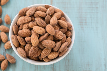 Almonds On Blue Wood Background From Above