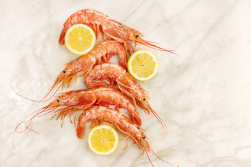 Raw shrimps with slices of lemon and copyspace
