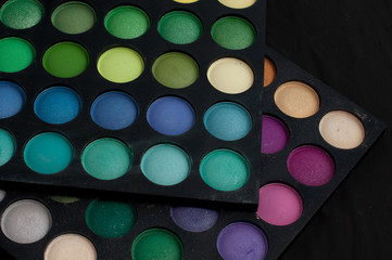 Palette of professional colorful eye shadows. Collection of multicolor eyeshadows. Makeup set background.