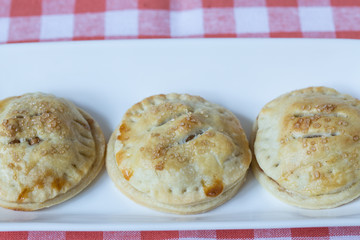 Apple Hand Pies In a Row On Red Napkin
