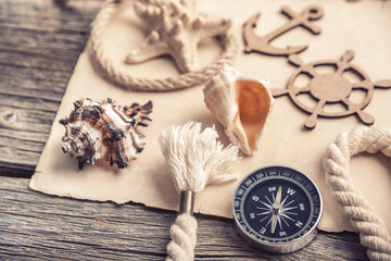 Compass, anchor, old paper with sea accessories.