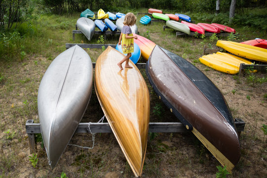 Girl standing on canoe keel 