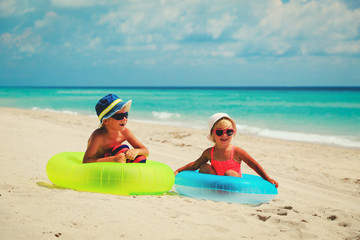 Fototapeta na wymiar cute little boy and girl play on beach