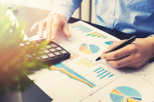 Man Analyzing And Working On Business Financial Reports In Office