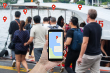 finder via gps - hand hold smartphone with blur port background