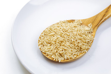 brown rice in wooden spoon