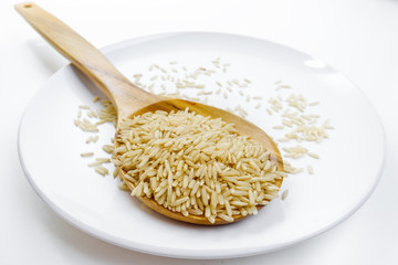brown rice in wood spoon