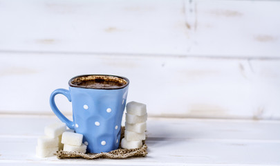 coffee cup with white sugar cubes. Unhealthy living concept 