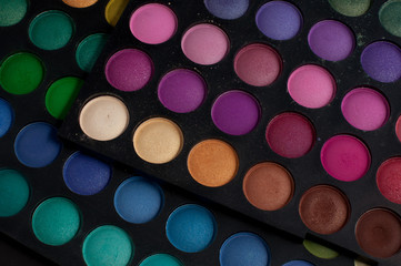 Palette of professional colorful eye shadows. Collection of multicolor eyeshadows. Makeup set background.
