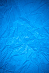 Blue paper crumpled recycle background.