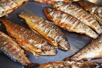 Fried fish in a frying pan on the cooker
