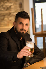 Elegant man drinking a beer