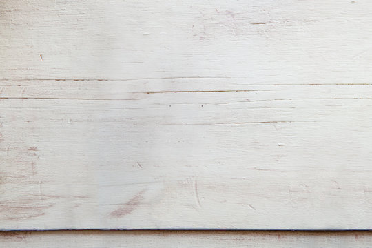 light green wooden top of a table with veins and signs of aging