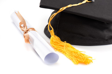 Close-up view of graduation mortarboard and diploma on white, education concept
