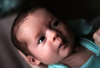 newborn little baby girl in parents hands