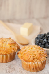 Blueberry Muffins Breakfast with Blueberries and Wood Spoon and Butter