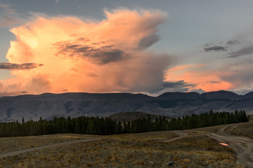 Obraz premium mountains clouds sunset pink road