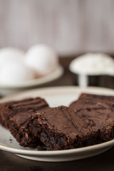 Brownies on a Plate With Eggs and Flour