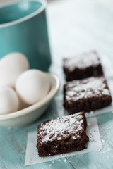 Brownies with Powdered Sugar With Eggs and Coffee Mug