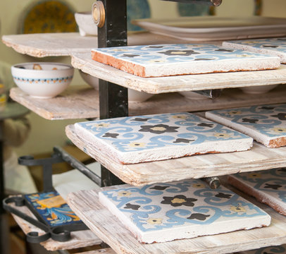 Closeup view of painted ceramic tiles in the shelf of a pottery workshop in Caltagirone, Sicily