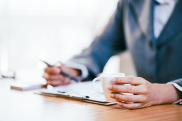 Fototapeta premium A businesswoman drink coffee while working in office