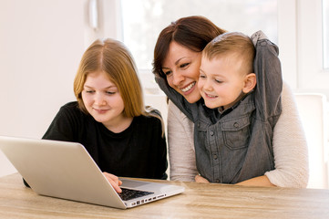 Mother and children web surfing at home