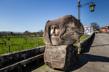 Granite sculpture on the Camino de Santiago in Ponte de Lima, Portugal, against blue sky