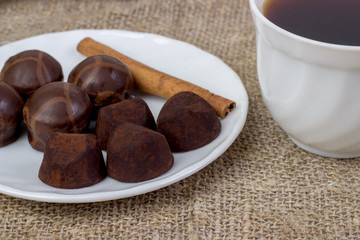 Coffee with assortment of chocolate, coffee beans, cinnamon