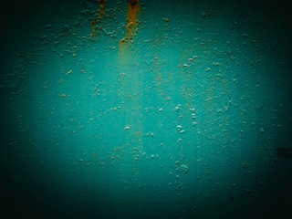 Abstract green texture with grunge cracks. Cracked paint on a metal surface. Bright urban background with rough paint transitions. The cracks grunge urban background.
