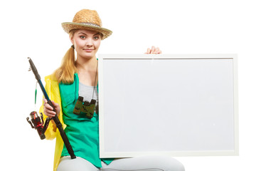 Happy woman with fishing rod holding board