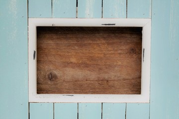A photo of a wooden frame with the colors white, blue, and brown. To use as invitations, advertising, menu card, and other occasions. A clear image or background with plenty of text space.