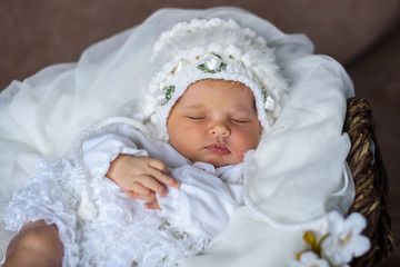 Fototapeta na wymiar sleeping baby on a white blanket in white clothes