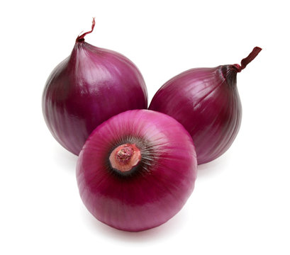 Three fresh bulbs of red onion isolated on white background