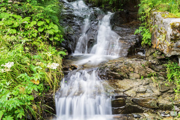 Naklejka na ściany i meble Waterfall on mountain river in Carpathian Mountains , Romania