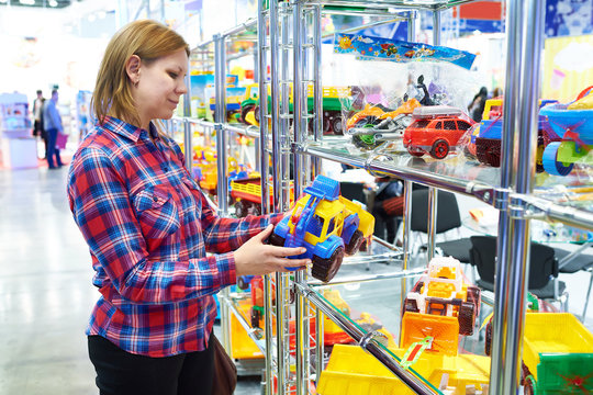 Woman Buys Toy Car In Children Store