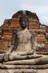 Ruins , buddha figure in front